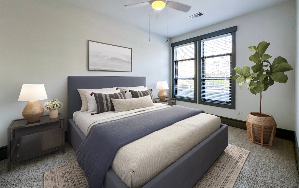 Bedroom with king-sized bed, carpet, and a large window at Chapel Hill North Apartments