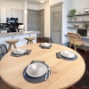 Dining area with a round table and the kitchen in the background at Chapel Hill North Apartments