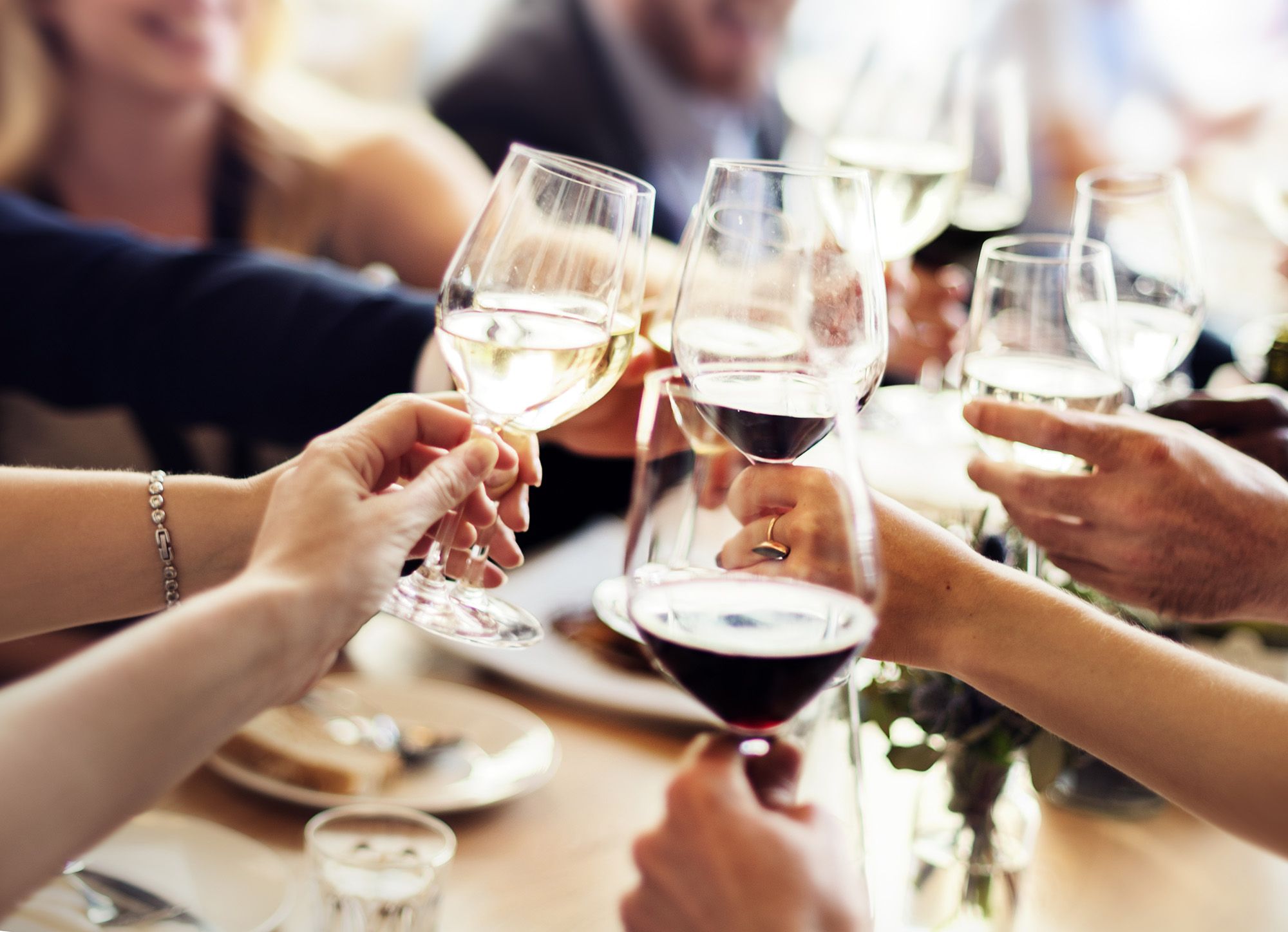 Chapel Hill North Apartments residents putting wine glasses in the air at a monthly resident event