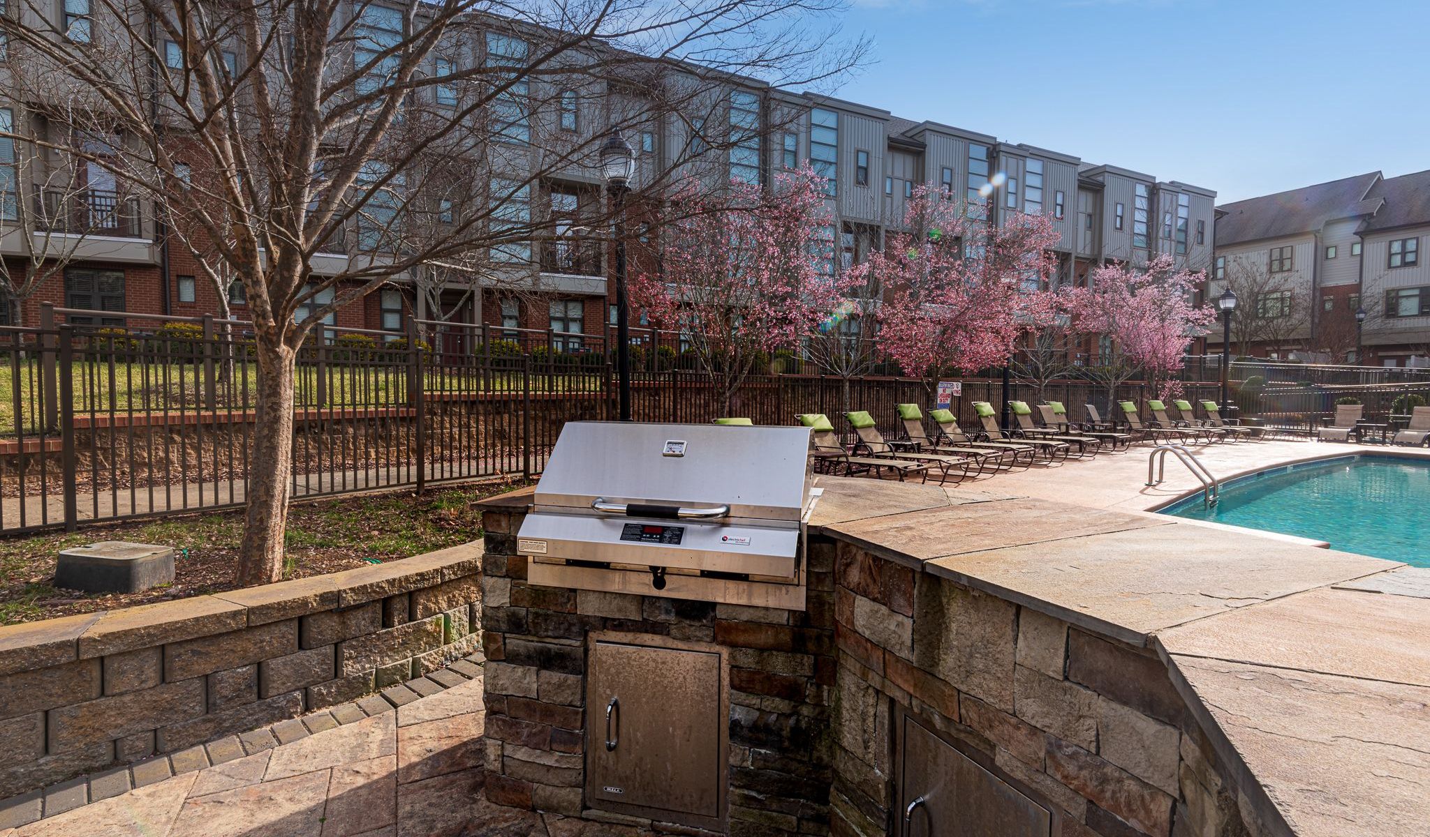 Chapel Hill North Apartments outdoor grilling station with stainless steel outdoor bbq grill and a stone bar area