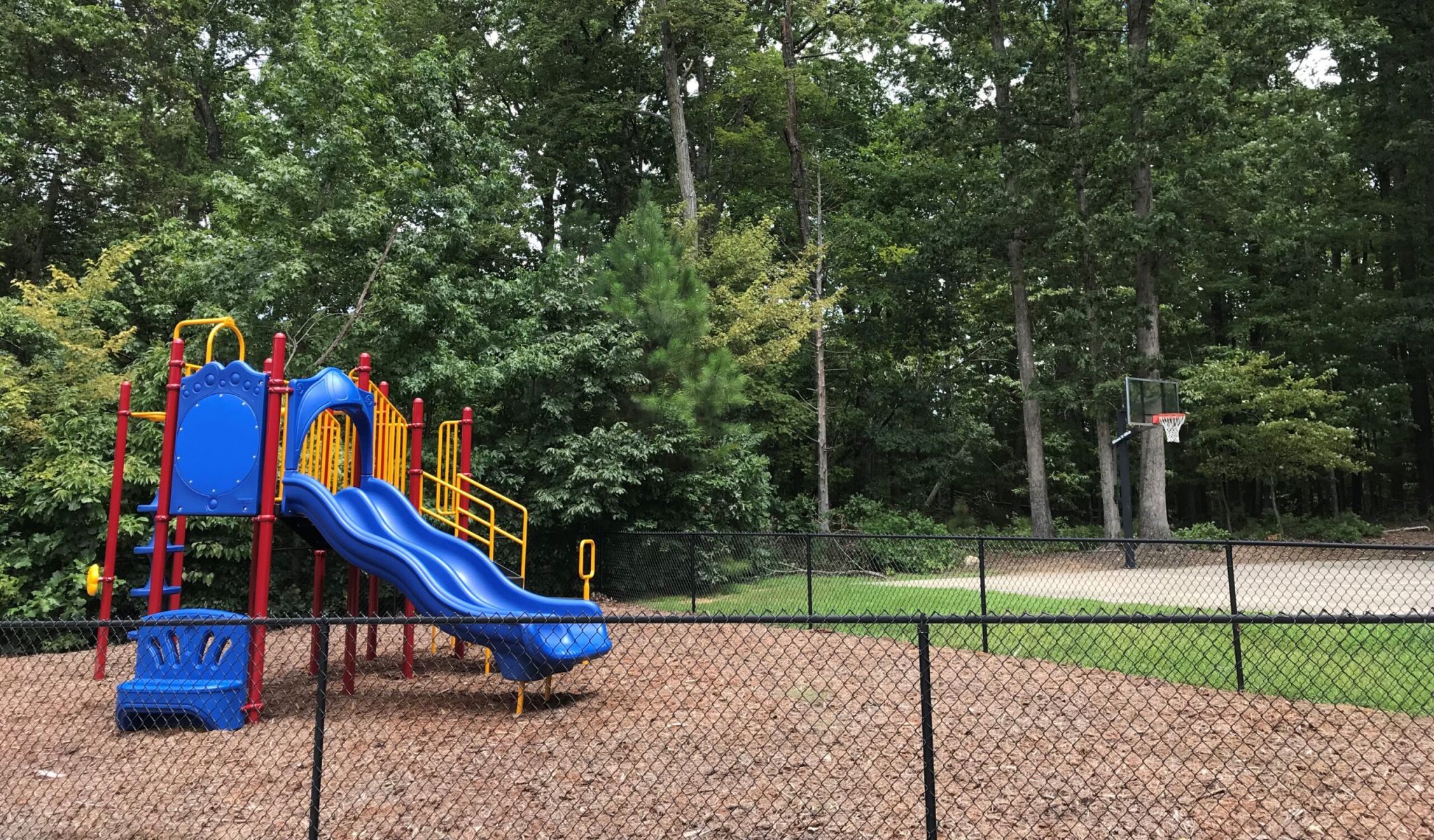Chapel Hill North apartments outdoor kids playground area in fenced in outdoor space
