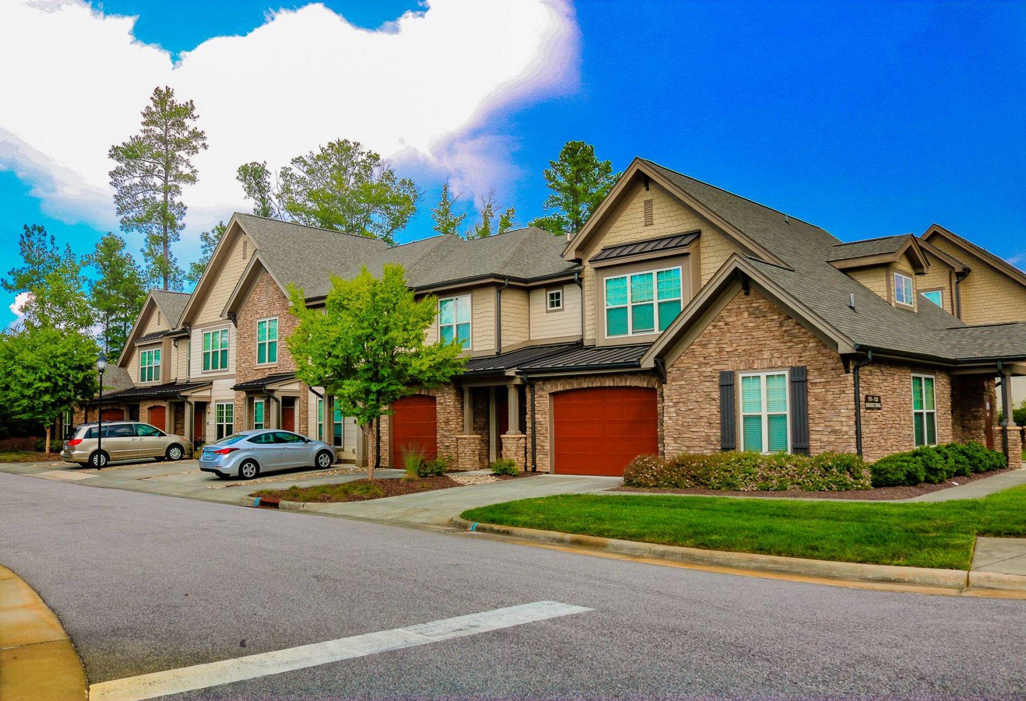 Townhomes at chapel watch village exterior view of townhouses with red garage doors in a beautiful style