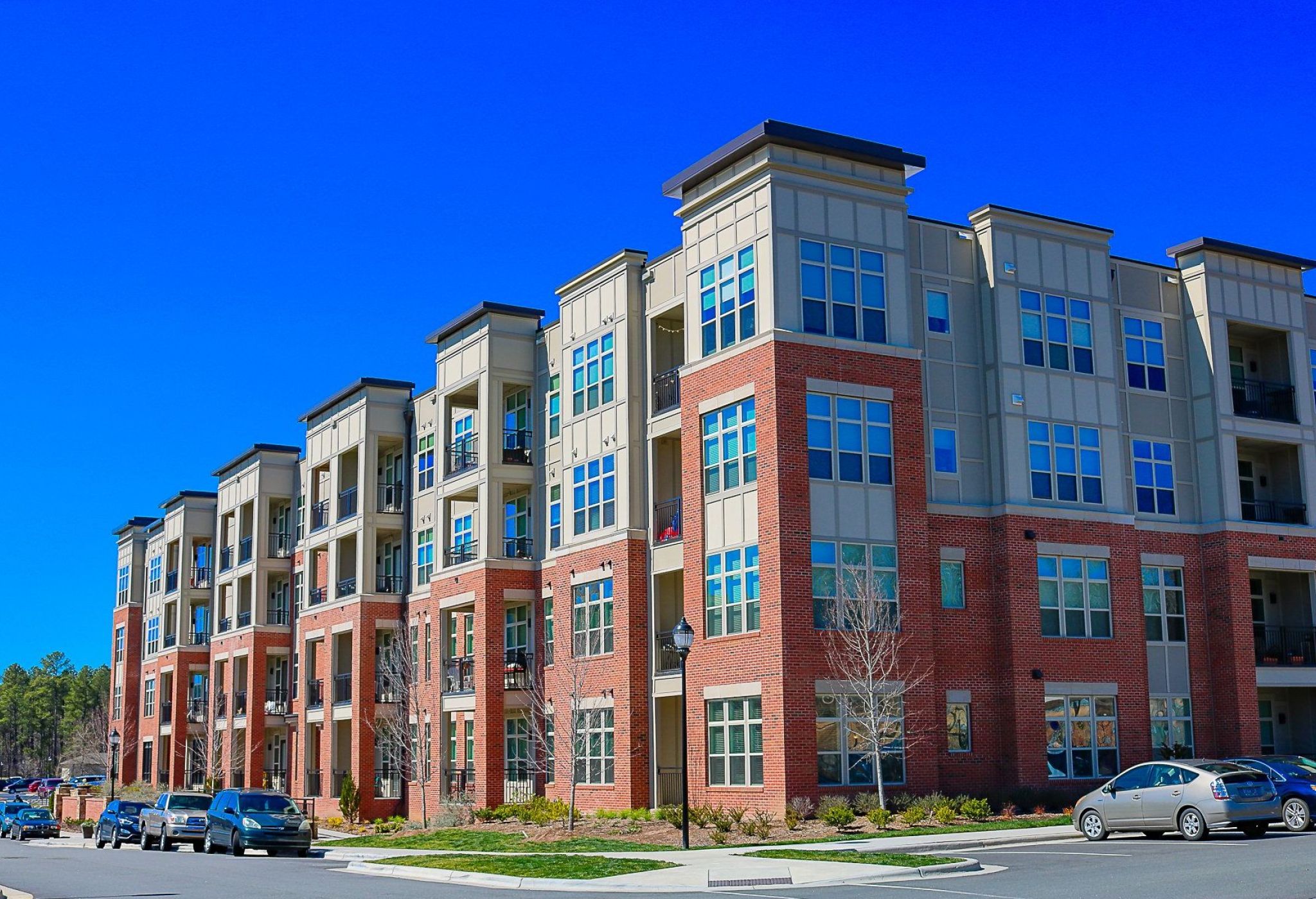 Apartments at Palladian Place exterior view from the street of apartment building with red and white siding