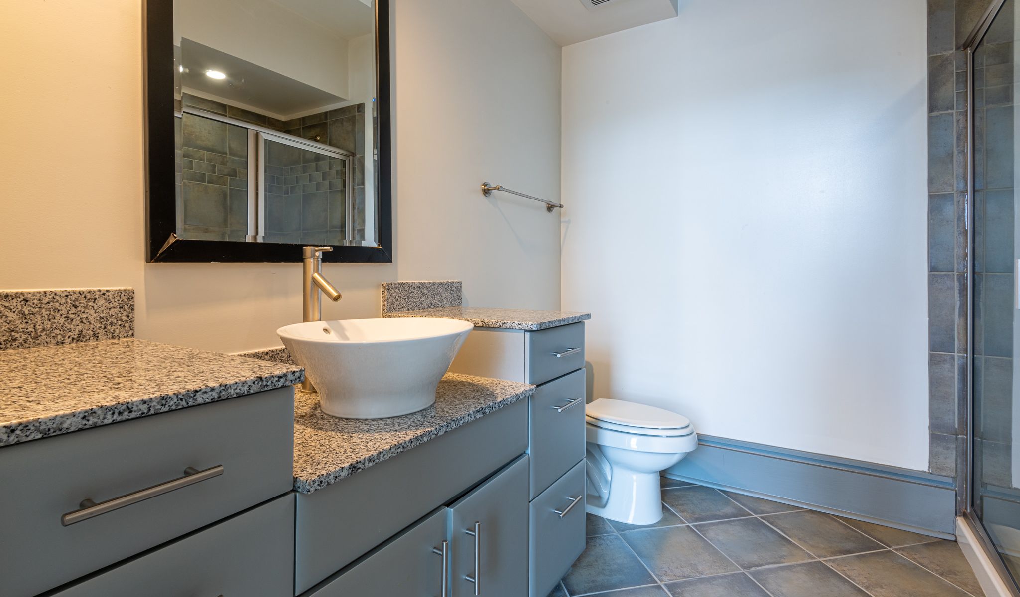 Chapel Hill North apartment bathroom with modern cabinetry and Vessel sinks 