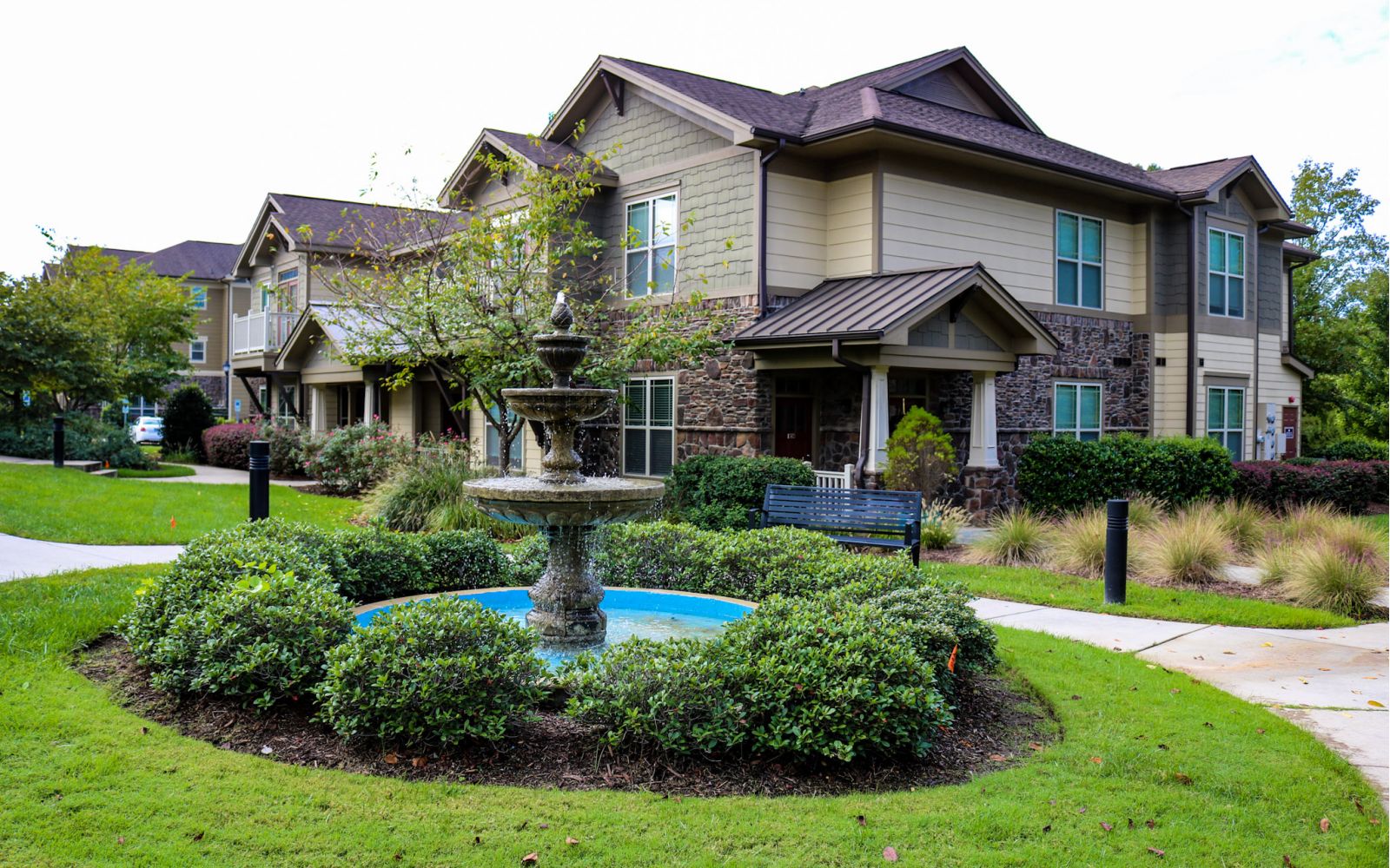 Cosgrove hill exterior townhouse view with fountain in the foreground and elegant townhouse in the background