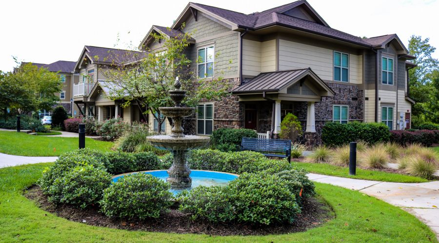 Cosgrove hill exterior townhouse view with fountain in the foreground and elegant townhouse in the background