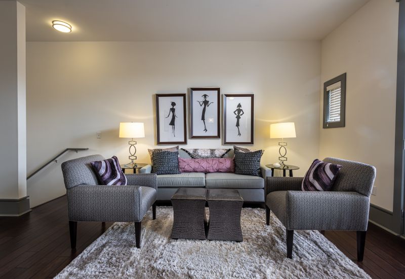 Chapel Hill north apartments living area with 2 chairs and a couch siting above a large rug on the floor