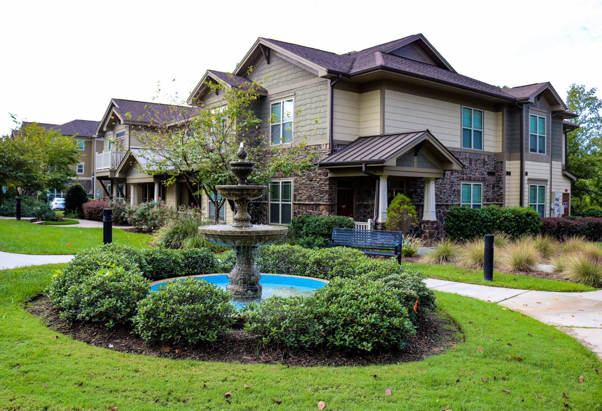 Cosgrove hill exterior townhouse view with fountain in the foreground and elegant townhouse in the background