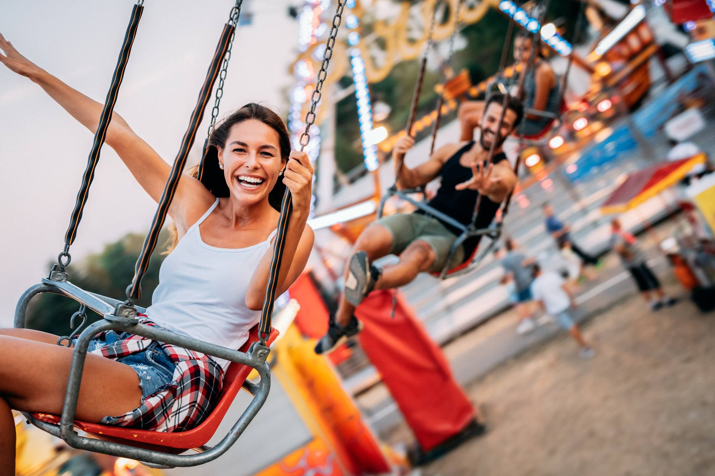 Young woman at a theme park on a swinging ride