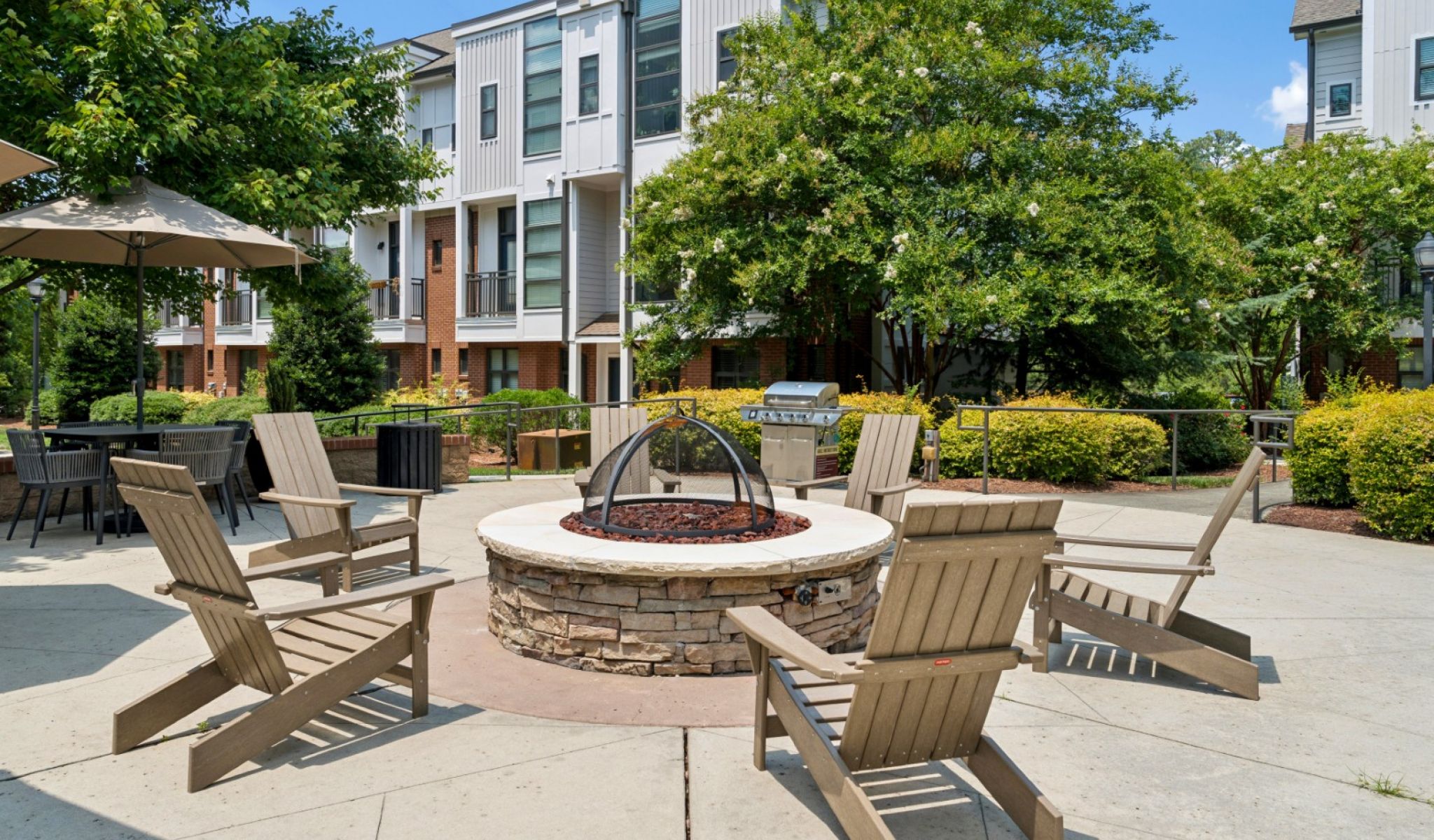 Chapel Hill North Apartments outdoor grilling station with stainless steel outdoor bbq grill and a stone bar area