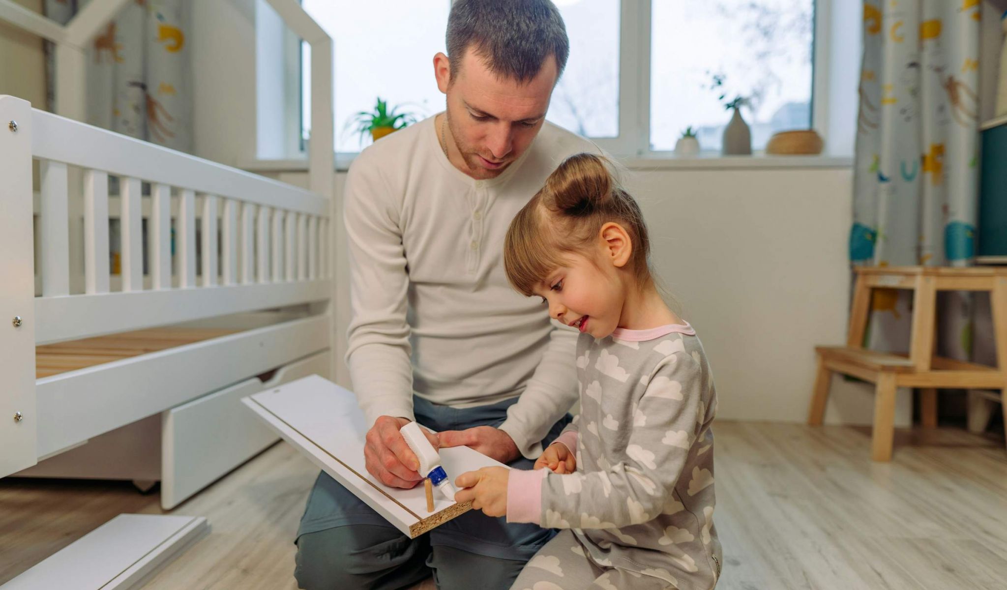 man with his daughter helping her with a school project