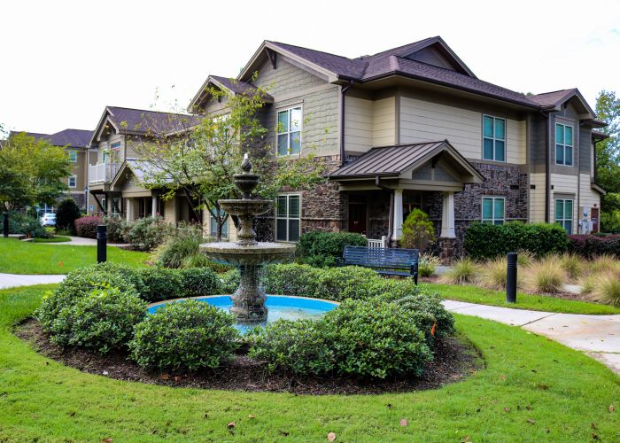 Cosgrove hill exterior townhouse view with fountain in the foreground and elegant townhouse in the background